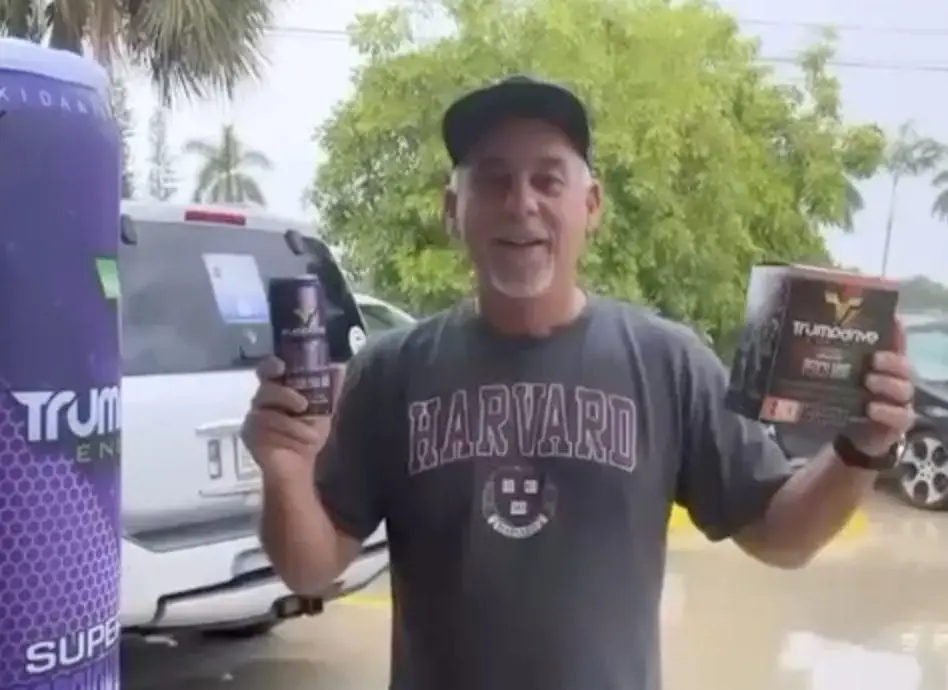 image of man holding trumpdrive energy drink
